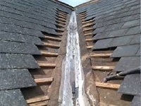 Leaking lead valley on a roof that is covered with slates.